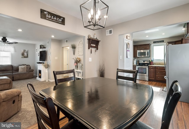 107 Philmar Ave, Cherry Hill, NJ 08003 - dining room with a chandelier, recessed lighting, light wood-type flooring, a warm lit fireplace, and ceiling fan