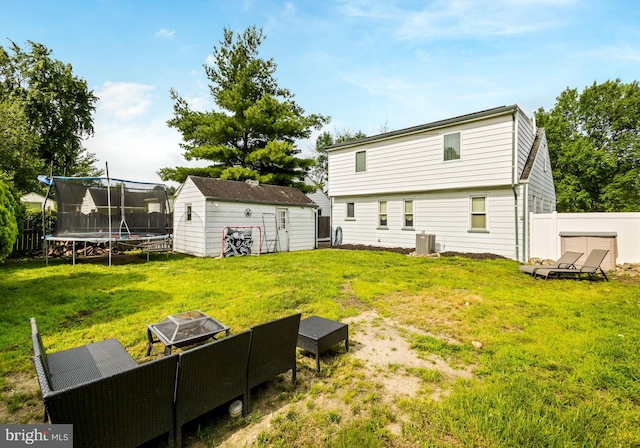 107 Philmar Ave, Cherry Hill, NJ 08003 - rear view of property featuring a storage shed, a trampoline, and a fire pit