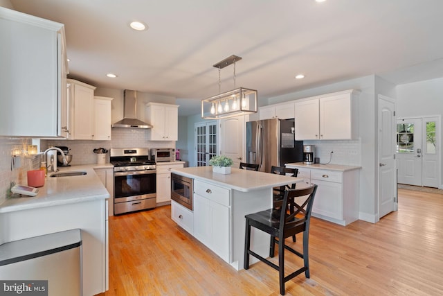 136 Tiller Ave, Manahawkin, NJ 08050 - kitchen with appliances with stainless steel finishes, wall chimney range hood, white cabinets, backsplash, and recessed lighting