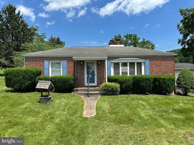 7819 Mentzer Gap Rd, Waynesboro, PA 17268 - view of front of home featuring brick siding, a front yard, roof with shingles, and a chimney