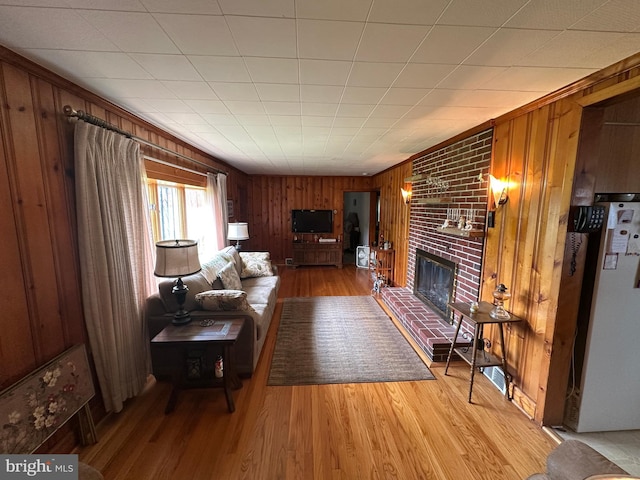 7819 Mentzer Gap Rd, Waynesboro, PA 17268 - living room with a brick fireplace, wood finished floors, and wood walls