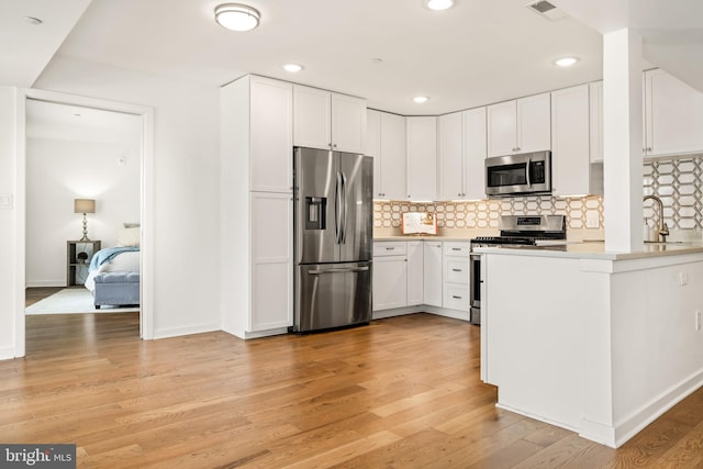 770 Fairview Ave Unit 770D, Annapolis, MD 21403 - kitchen with appliances with stainless steel finishes, light wood finished floors, white cabinets, and recessed lighting