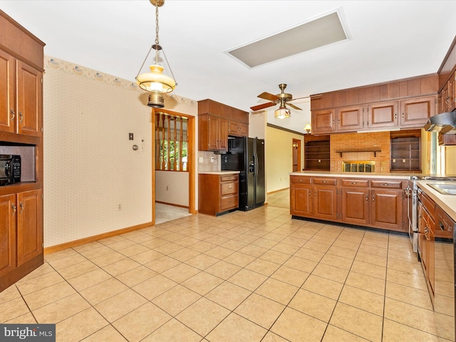 6505 Morningside Ct, Middletown, MD 21769 - kitchen with black appliances, light countertops, wallpapered walls, decorative light fixtures, and brown cabinetry