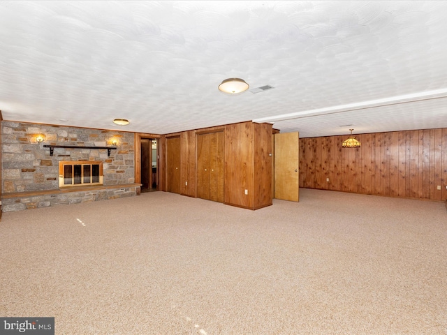 6505 Morningside Ct, Middletown, MD 21769 - unfurnished living room featuring wood walls, carpet floors, and a fireplace