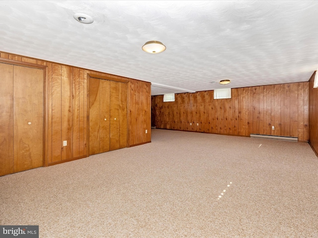 6505 Morningside Ct, Middletown, MD 21769 - basement with wood walls, a baseboard radiator, and carpet flooring