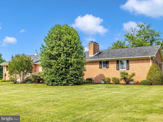 6505 Morningside Ct, Middletown, MD 21769 - view of side of home with brick siding, a lawn, and a chimney