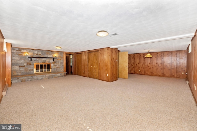 6505 Morningside Ct, Middletown, MD 21769 - unfurnished living room featuring wood walls, carpet floors, and a fireplace