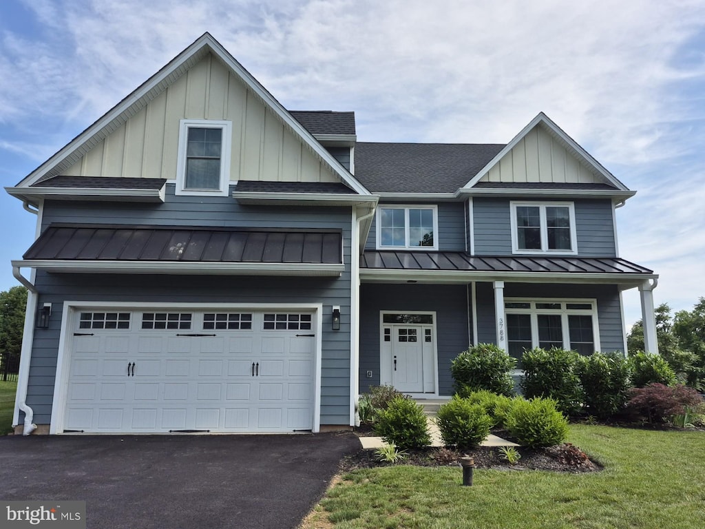 3788 Drake Cir, Collegeville, PA 19426 - view of front facade with a standing seam roof, a shingled roof, board and batten siding, and an attached garage