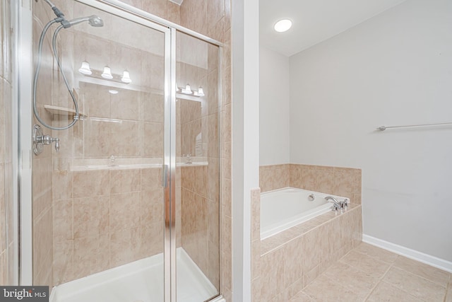9711 Handerson Pl Unit 206, Manassas Park, VA 20111 - bathroom with a shower stall, a garden tub, and tile patterned floors