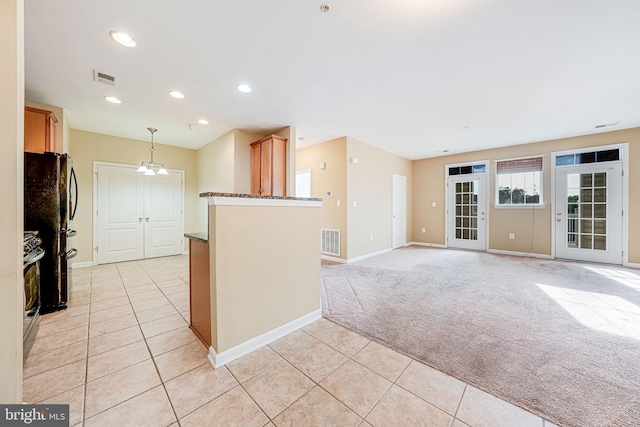 9711 Handerson Pl Unit 206, Manassas Park, VA 20111 - kitchen featuring light tile patterned flooring, light colored carpet, pendant lighting, freestanding refrigerator, and recessed lighting