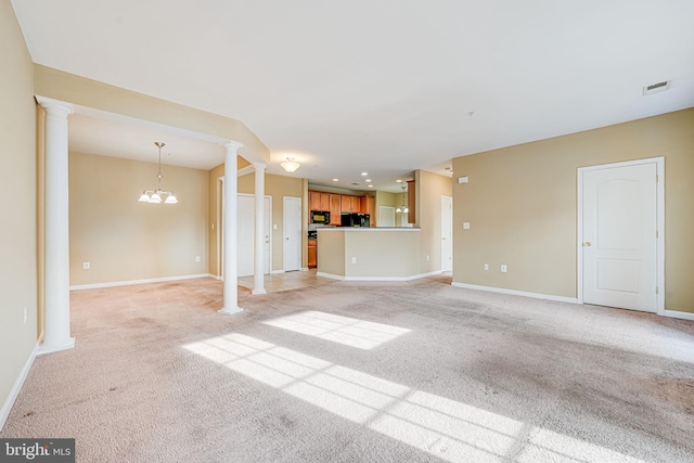 9711 Handerson Pl Unit 206, Manassas Park, VA 20111 - unfurnished living room with decorative columns, light carpet, and a chandelier