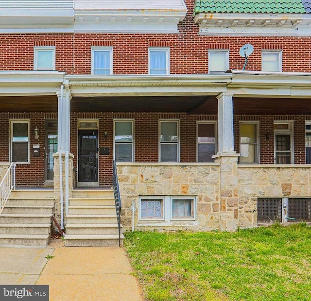 2308 W Mosher St, Baltimore, MD 21216 - view of front of home with covered porch, stone siding, and brick siding