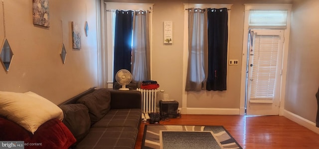 2308 W Mosher St, Baltimore, MD 21216 - living area featuring wood finished floors and radiator