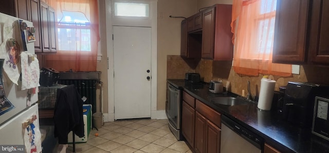 2308 W Mosher St, Baltimore, MD 21216 - kitchen with stainless steel appliances, healthy amount of natural light, dark countertops, and light tile patterned floors