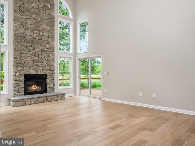 1015 S Creek View Ct, Churchton, MD 20733 - unfurnished living room featuring a high ceiling, light wood-style floors, and a fireplace