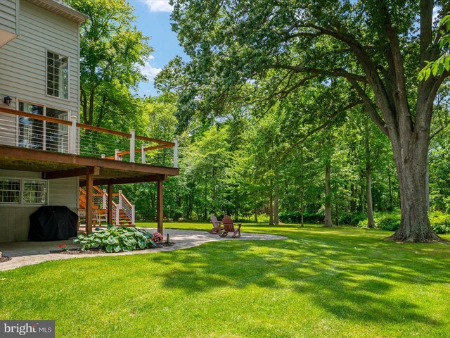 1015 S Creek View Ct, Churchton, MD 20733 - view of green lawn with stairway, a deck, and a patio area