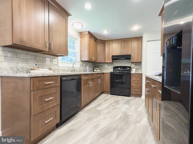 5646 Mount Burnside Way, Burke, VA 22015 - kitchen featuring black appliances, under cabinet range hood, backsplash, light stone countertops, and brown cabinetry