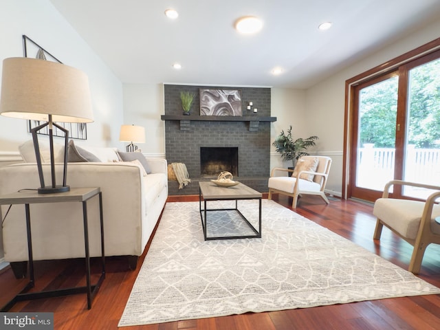 5646 Mount Burnside Way, Burke, VA 22015 - living room with wood finished floors, a brick fireplace, and recessed lighting