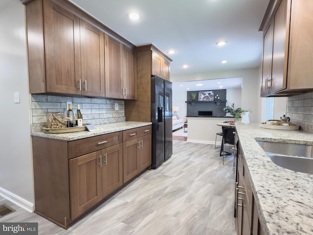5646 Mount Burnside Way, Burke, VA 22015 - kitchen with fridge with ice dispenser, backsplash, light stone countertops, and recessed lighting