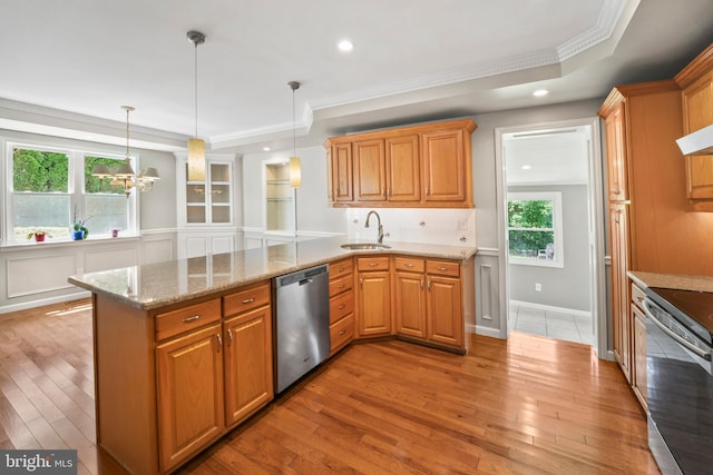 51 E Ann Rd, Broomall, PA 19008 - kitchen with stainless steel appliances, light wood finished floors, a peninsula, light stone counters, and decorative light fixtures