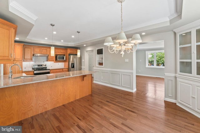 51 E Ann Rd, Broomall, PA 19008 - kitchen with appliances with stainless steel finishes, a raised ceiling, under cabinet range hood, wood finished floors, and recessed lighting