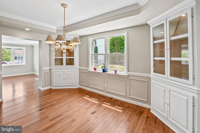 51 E Ann Rd, Broomall, PA 19008 - unfurnished dining area featuring a chandelier, light wood finished floors, ornamental molding, a decorative wall, and a wainscoted wall