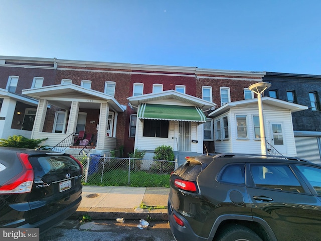 3137 Oakford Ave, Baltimore, MD 21215 - townhome / multi-family property with a fenced front yard