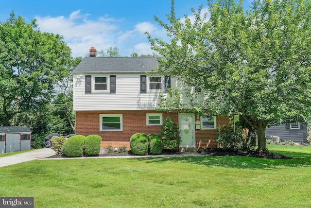2303 Mulberry Ln, Lafayette Hill, PA 19444 - colonial-style house with brick siding, a front yard, and a chimney