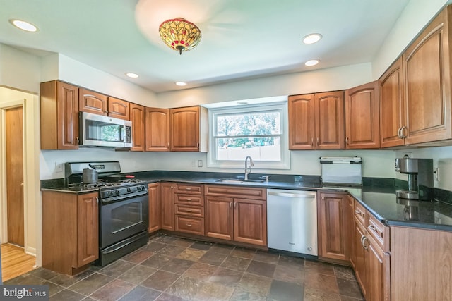 2303 Mulberry Ln, Lafayette Hill, PA 19444 - kitchen with stainless steel appliances, dark countertops, brown cabinets, and recessed lighting