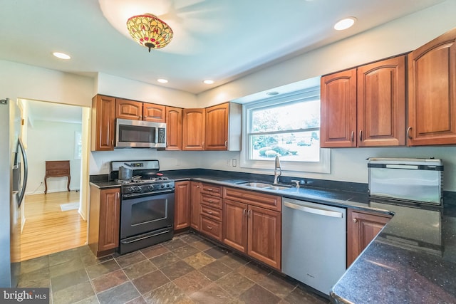 2303 Mulberry Ln, Lafayette Hill, PA 19444 - kitchen with appliances with stainless steel finishes, brown cabinets, recessed lighting, dark stone counters, and dark stone finish flooring