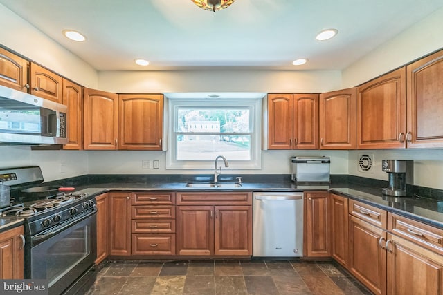 2303 Mulberry Ln, Lafayette Hill, PA 19444 - kitchen with stainless steel appliances, brown cabinetry, recessed lighting, dark stone finish flooring, and dark stone countertops