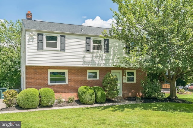 2303 Mulberry Ln, Lafayette Hill, PA 19444 - view of front of house featuring brick siding, a front yard, a chimney, and a shingled roof
