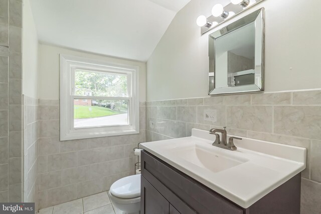 2303 Mulberry Ln, Lafayette Hill, PA 19444 - bathroom featuring vaulted ceiling, tile walls, vanity, and wainscoting