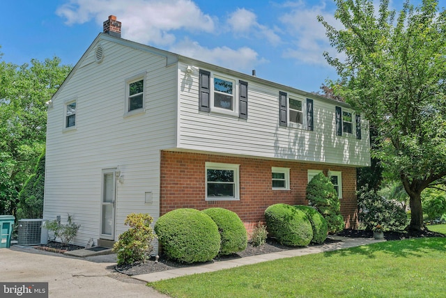 2303 Mulberry Ln, Lafayette Hill, PA 19444 - view of side of home with a chimney, brick siding, and a lawn