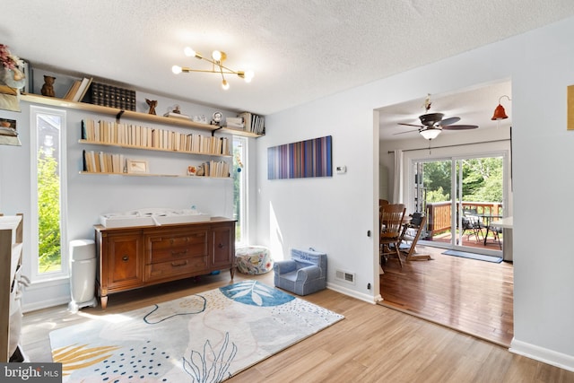 3086 Bridgeton Ct, Woodbridge, VA 22192 - interior space with a textured ceiling, wood finished floors, a chandelier, and ceiling fan