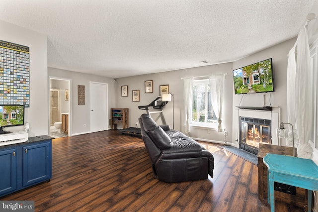 3086 Bridgeton Ct, Woodbridge, VA 22192 - living room with dark wood-style flooring, a textured ceiling, and a fireplace with flush hearth