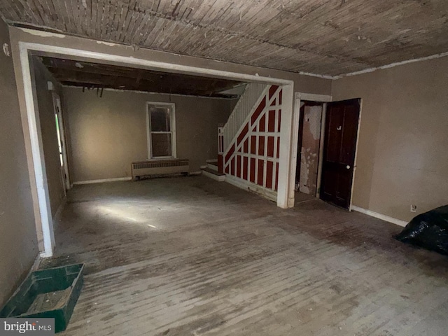 381 National Ave, Winchester, VA 22601 - unfurnished room featuring wood finished floors, radiator, and stairs