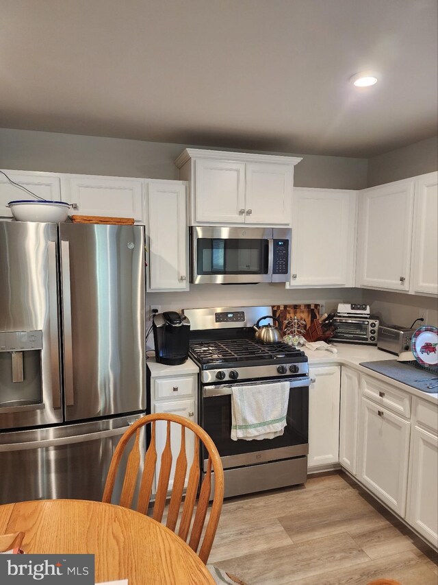 100 Senators Way, Berlin, NJ 08009 - kitchen featuring appliances with stainless steel finishes, white cabinetry, light wood-type flooring, light countertops, and recessed lighting