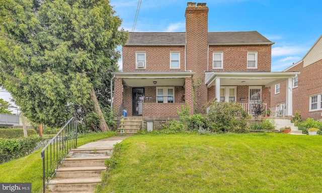 438 Holly Rd, Lansdowne, PA 19050 - view of front of house featuring a chimney, brick siding, and a front lawn
