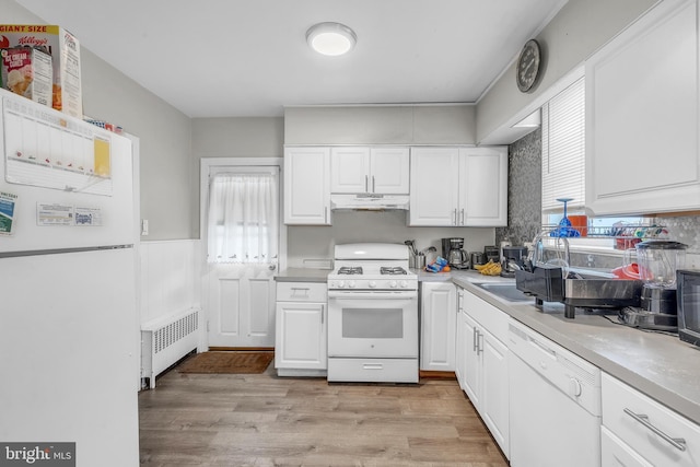 438 Holly Rd, Lansdowne, PA 19050 - kitchen with white appliances, radiator, under cabinet range hood, healthy amount of natural light, and wainscoting