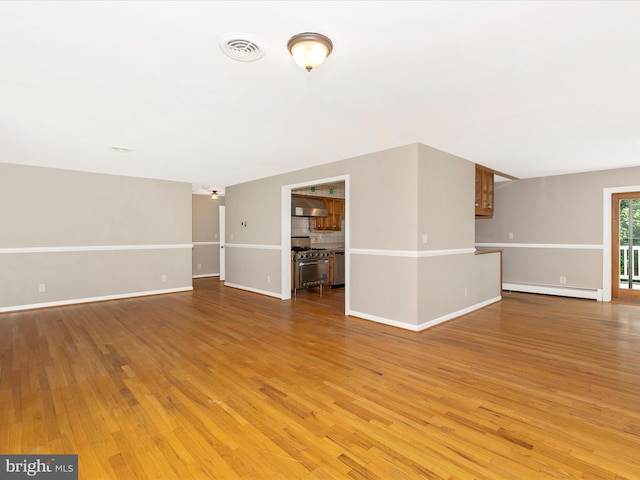 4431 Cherry Tree Ln, Sykesville, MD 21784 - unfurnished living room featuring baseboard heating and light wood-style floors