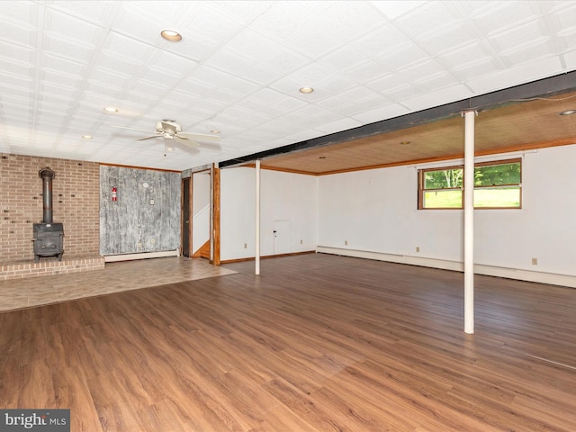 4431 Cherry Tree Ln, Sykesville, MD 21784 - below grade area featuring a baseboard heating unit, wood finished floors, a wood stove, ceiling fan, and recessed lighting