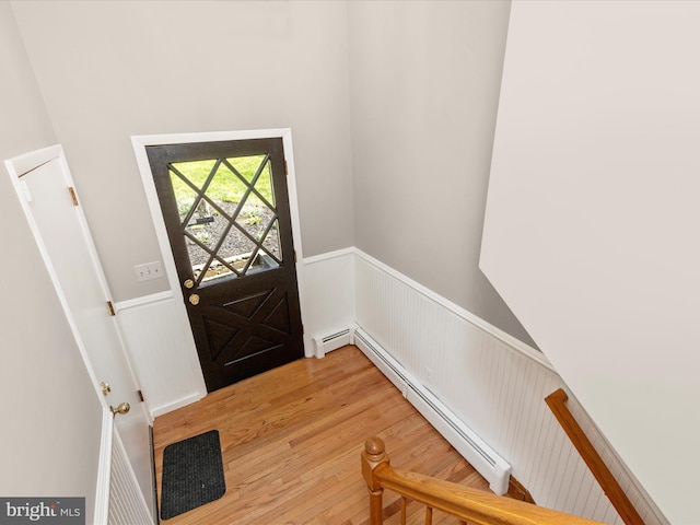 4431 Cherry Tree Ln, Sykesville, MD 21784 - foyer featuring a baseboard heating unit, wainscoting, light wood-style floors, and a towering ceiling