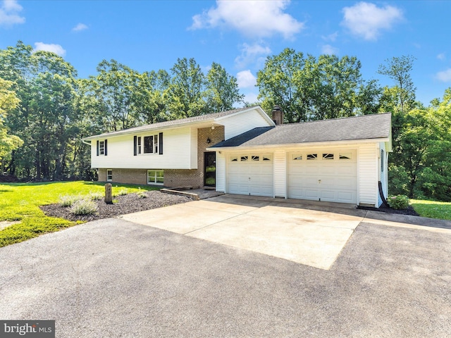 4431 Cherry Tree Ln, Sykesville, MD 21784 - view of front of house with concrete driveway, a chimney, an attached garage, and brick siding