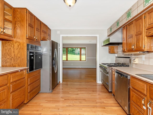 4431 Cherry Tree Ln, Sykesville, MD 21784 - kitchen with stainless steel appliances, light wood-type flooring, under cabinet range hood, and brown cabinets