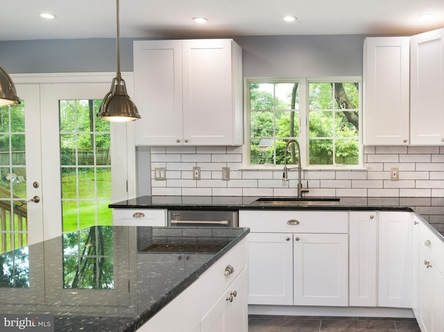 319 W Conestoga Rd, Devon, PA 19333 - kitchen featuring decorative backsplash, white cabinetry, dark stone counters, hanging light fixtures, and recessed lighting