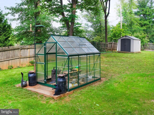 319 W Conestoga Rd, Devon, PA 19333 - fenced backyard featuring an outdoor structure and a greenhouse