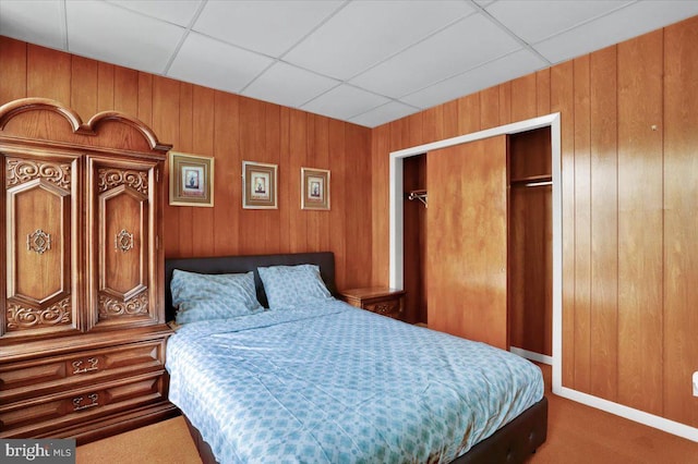 1243 Buttonwood St, Reading, PA 19604 - bedroom featuring wood walls, carpet floors, a paneled ceiling, and a closet