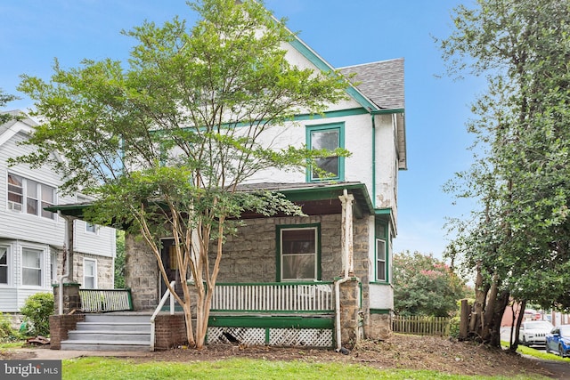 29 N Maple Ave, Lansdowne, PA 19050 - view of front of house with a porch, stone siding, and a shingled roof
