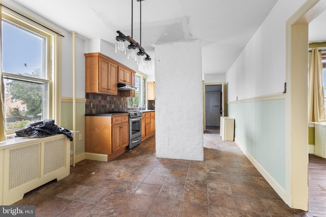 29 N Maple Ave, Lansdowne, PA 19050 - kitchen with stainless steel range with electric cooktop, brown cabinetry, stone finish floors, under cabinet range hood, and decorative backsplash